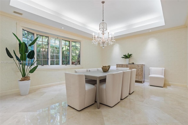 dining room featuring ornamental molding, a raised ceiling, and a notable chandelier