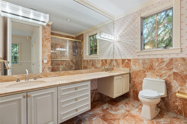 bathroom with vanity, a healthy amount of sunlight, crown molding, and a shower with shower door