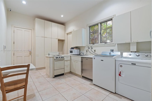 kitchen with white cabinetry, range, and independent washer and dryer