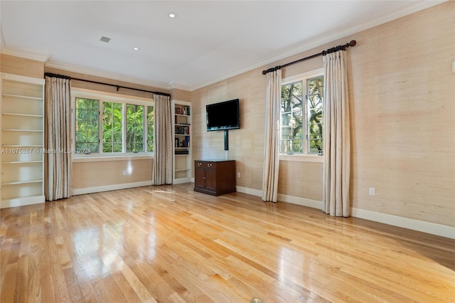 unfurnished living room featuring ornamental molding and light hardwood / wood-style flooring