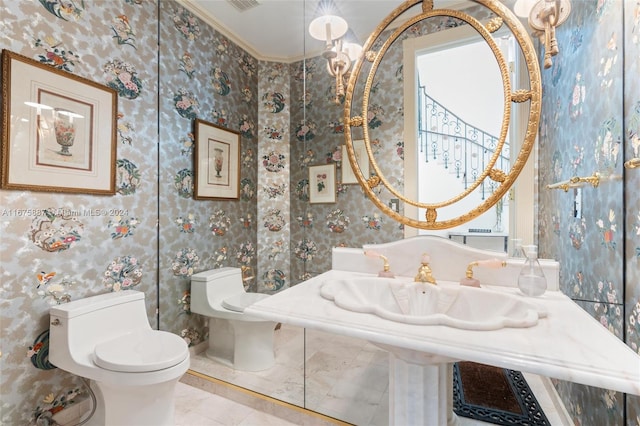 bathroom with tile patterned flooring, toilet, and ornamental molding