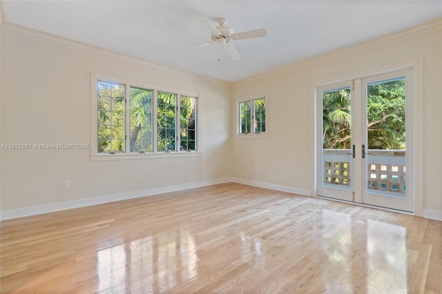 empty room featuring french doors, ceiling fan, crown molding, and light wood-type flooring