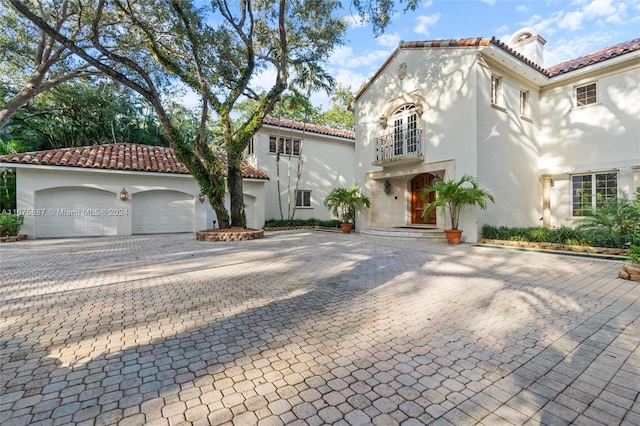 mediterranean / spanish home featuring a garage