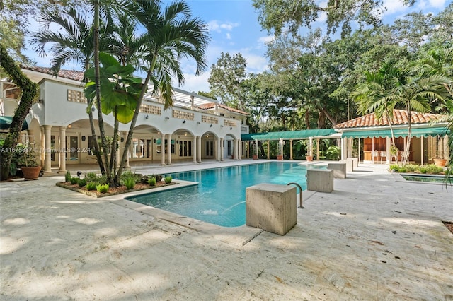 view of swimming pool featuring a patio area