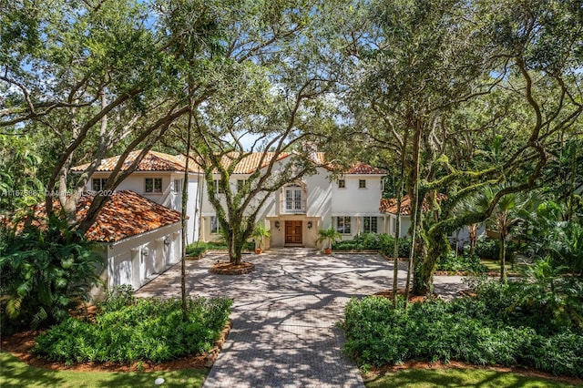 mediterranean / spanish-style home with a garage