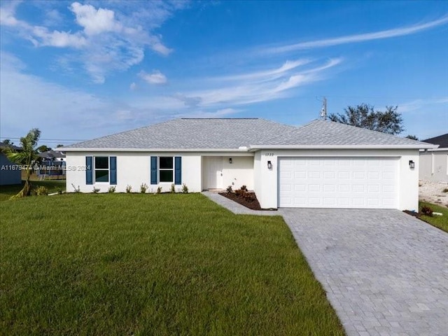 ranch-style house featuring a garage and a front lawn