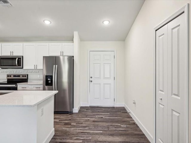 kitchen featuring white cabinetry, stainless steel appliances, and dark wood-type flooring