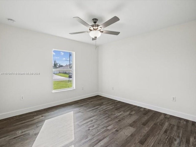 unfurnished room featuring dark hardwood / wood-style floors and ceiling fan