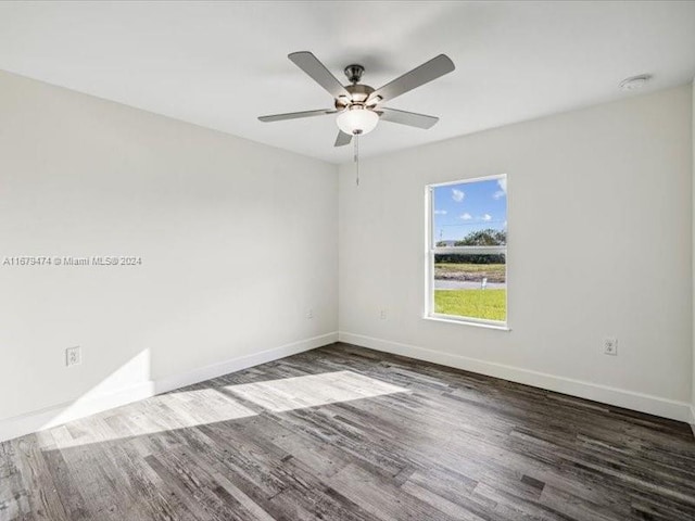 empty room with dark wood-type flooring and ceiling fan