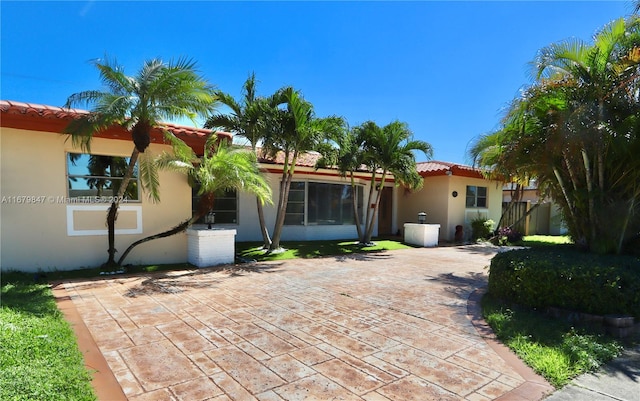 rear view of property featuring a patio area