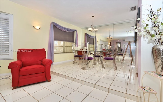 tiled dining area featuring an inviting chandelier