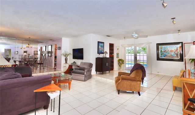 tiled living room with french doors and ceiling fan