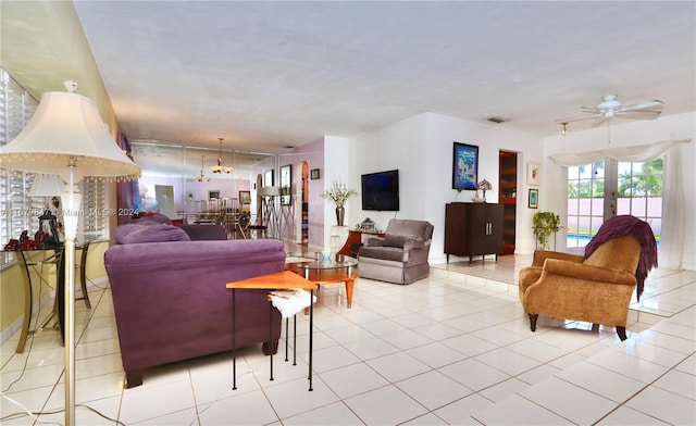 tiled living room with french doors and ceiling fan