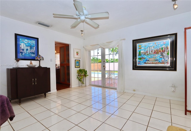 spare room featuring french doors, ceiling fan, and light tile patterned floors