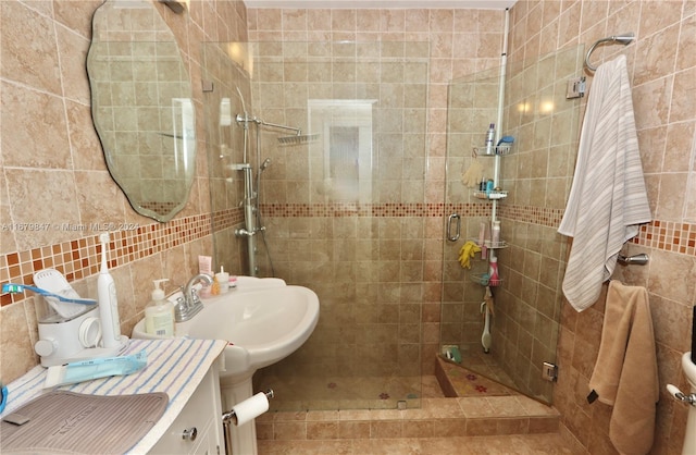 bathroom with tile walls, vanity, tasteful backsplash, and walk in shower