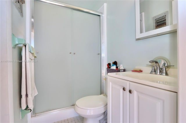 bathroom with vanity, toilet, walk in shower, and tile patterned flooring