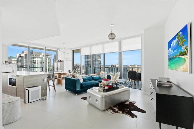 living room featuring an inviting chandelier and expansive windows