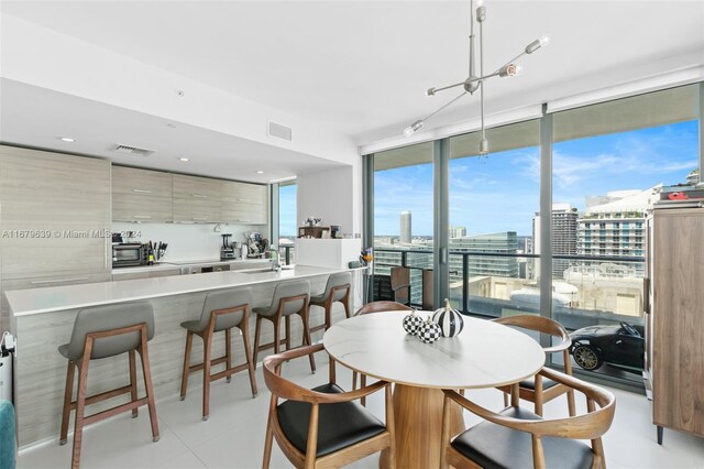 dining space with light tile patterned flooring and plenty of natural light