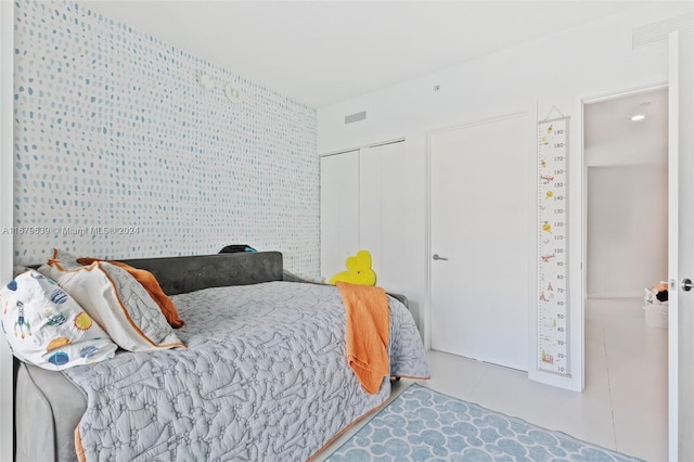 tiled bedroom featuring a closet