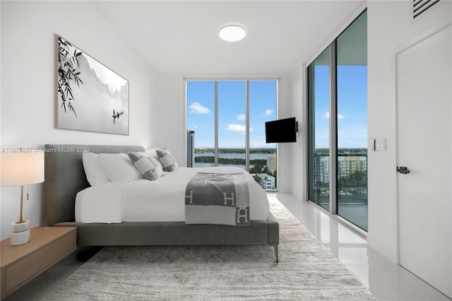 bedroom featuring access to outside, a wall of windows, and visible vents