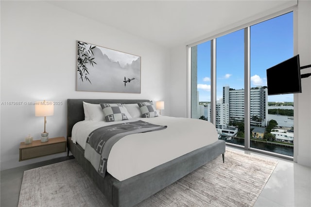 bedroom featuring access to exterior and a wall of windows