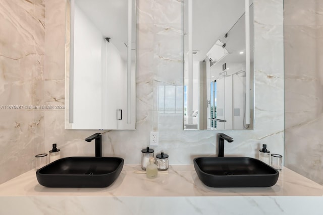 bathroom featuring tasteful backsplash, tile walls, and a sink