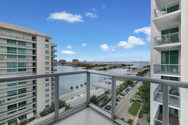 balcony with a water view and a city view