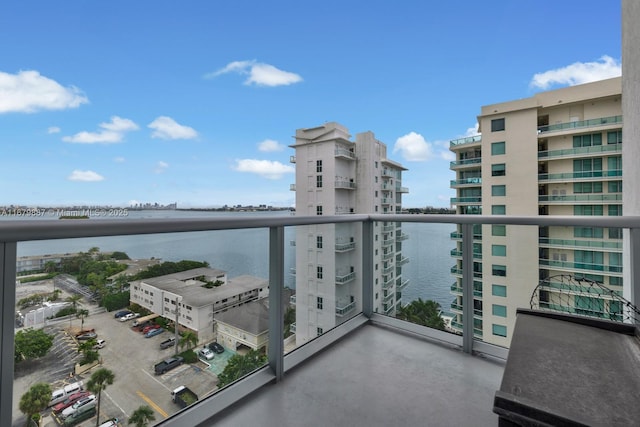 balcony featuring a water view and a view of city