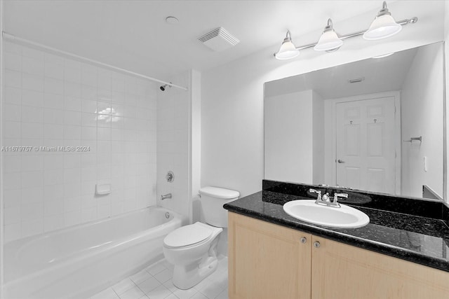 full bathroom featuring toilet, tiled shower / bath, vanity, and tile patterned flooring