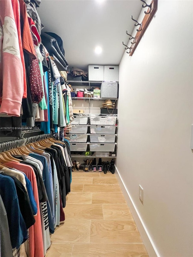 spacious closet featuring light hardwood / wood-style floors