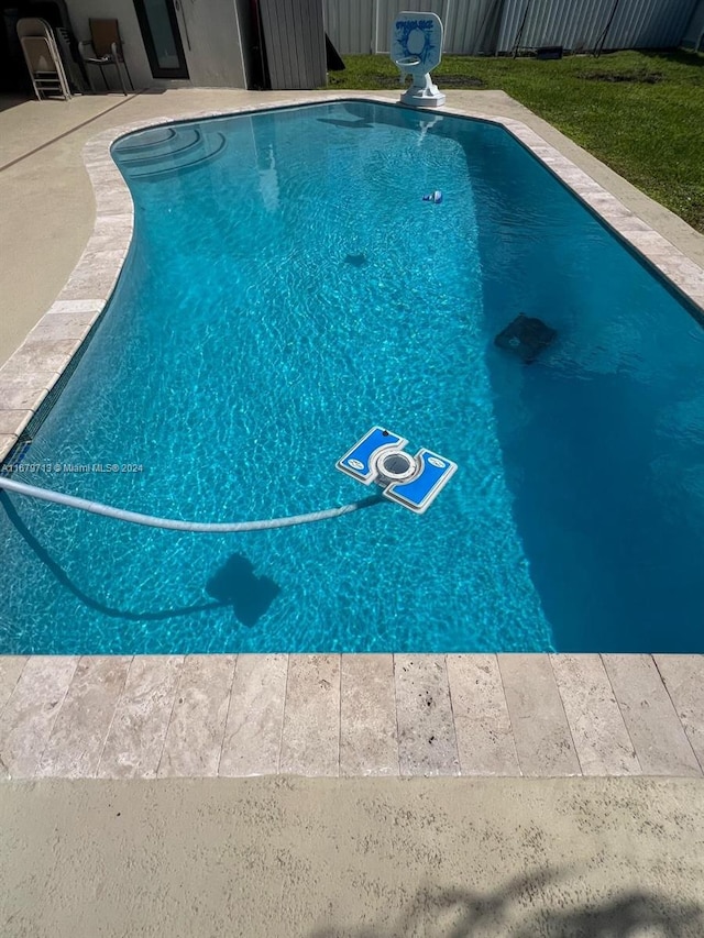 view of swimming pool with a patio