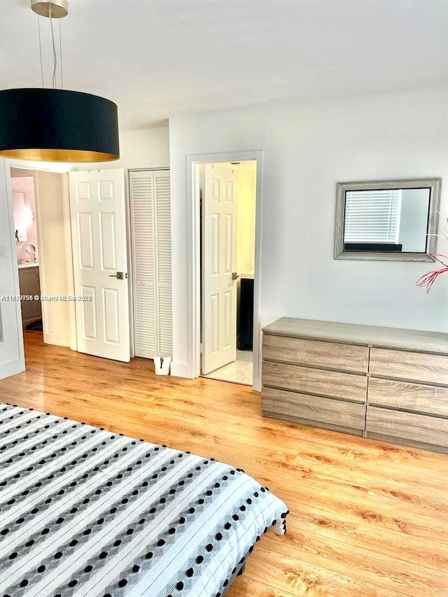 bedroom featuring light wood-style flooring and a closet