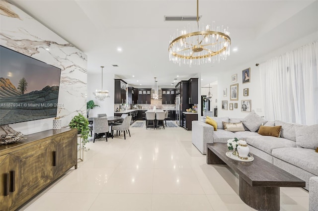 tiled living room featuring an inviting chandelier