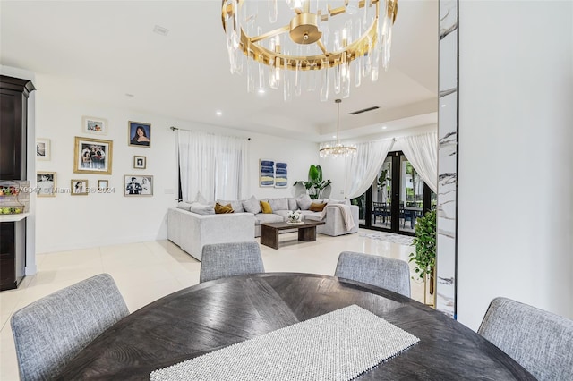 dining area with light tile patterned floors and an inviting chandelier