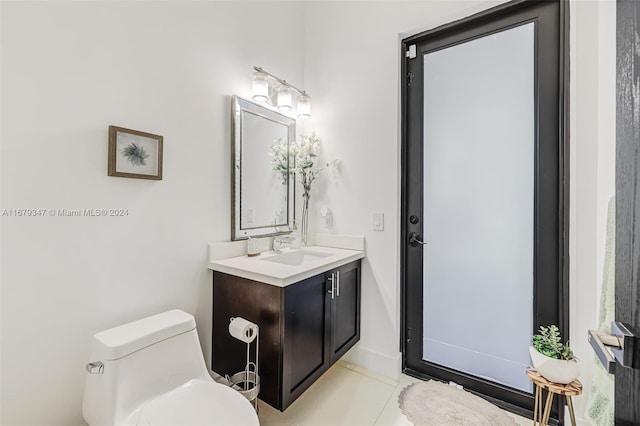 bathroom with vanity, toilet, and tile patterned flooring