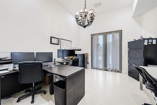 office space with high vaulted ceiling, light tile patterned flooring, and an inviting chandelier