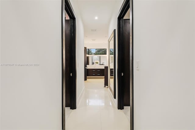 hall featuring light tile patterned flooring