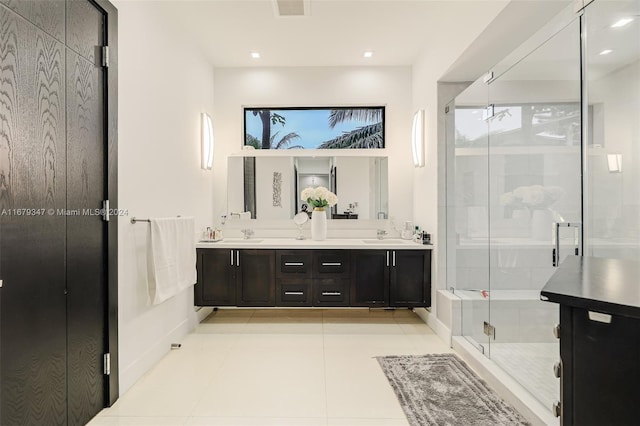 bathroom featuring vanity, walk in shower, and tile patterned flooring