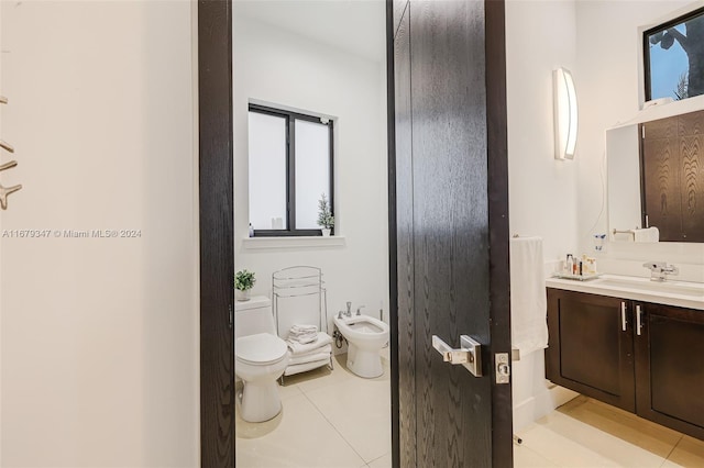 bathroom featuring vanity, a bidet, toilet, and tile patterned flooring