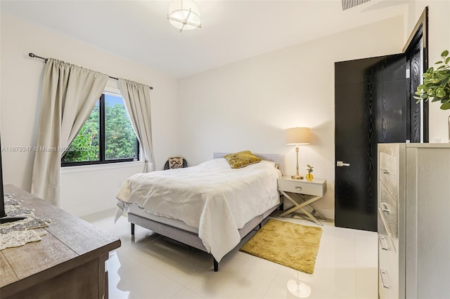 bedroom with light tile patterned floors