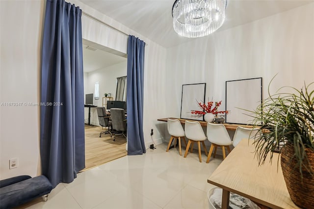 dining room featuring a chandelier and tile patterned flooring