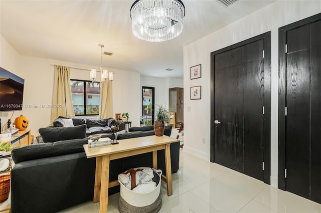 living room featuring a notable chandelier and light tile patterned floors