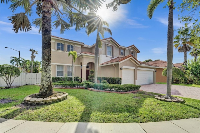 mediterranean / spanish house featuring a garage and a front lawn