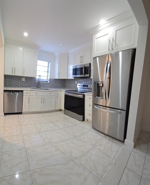 kitchen featuring sink, white cabinetry, and stainless steel appliances