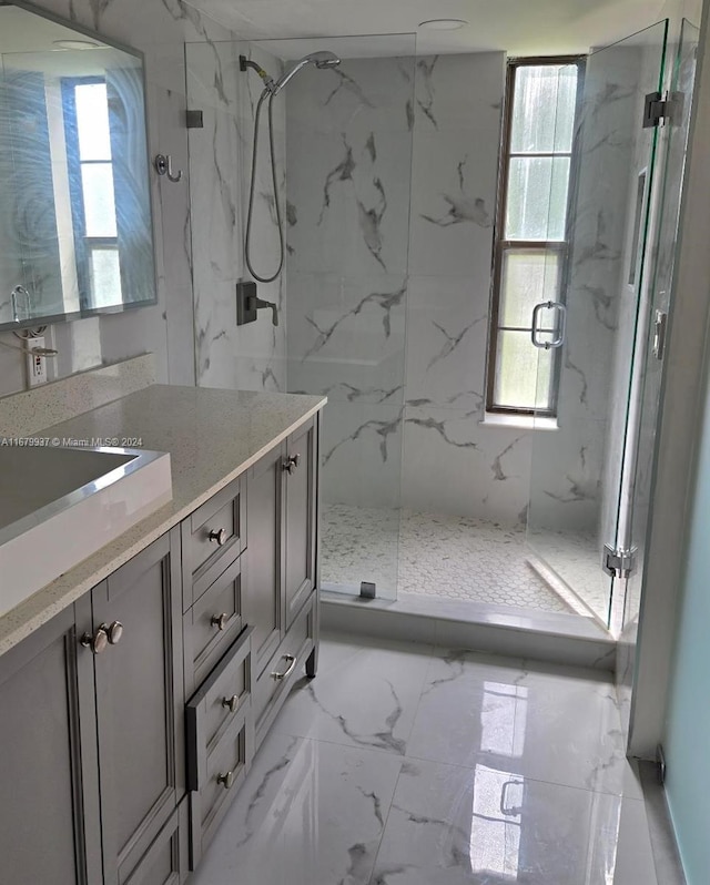 bathroom with vanity, walk in shower, and plenty of natural light