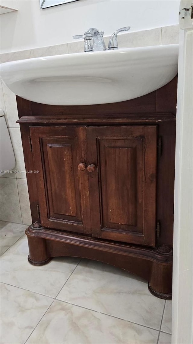 interior details with vanity and tile patterned flooring