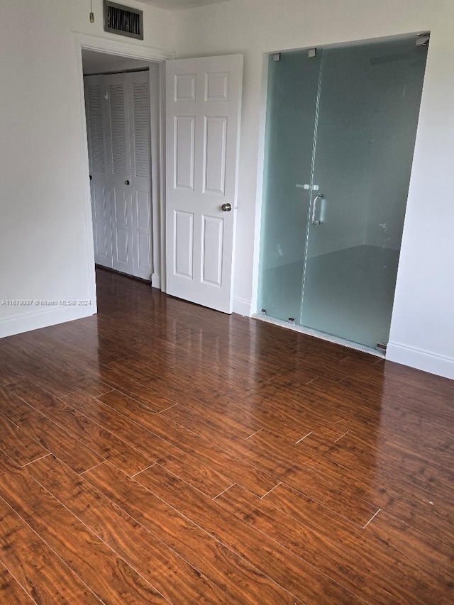 empty room with dark hardwood / wood-style floors