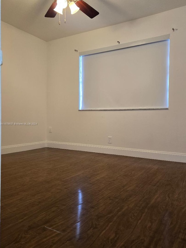 empty room featuring dark hardwood / wood-style floors and ceiling fan