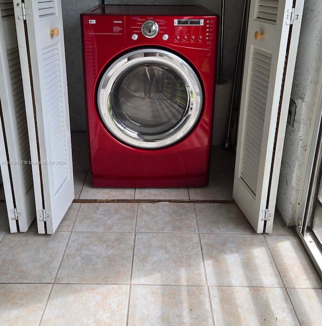 washroom featuring washer / dryer and light tile patterned floors