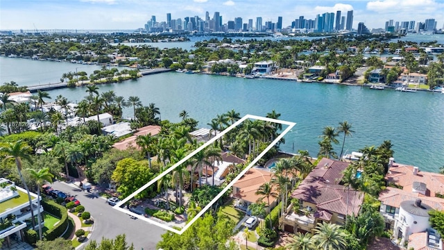 birds eye view of property with a water view, a residential view, and a view of city